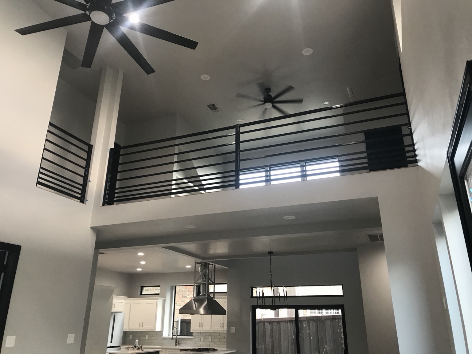 Custom black metal railing and second-story overlook